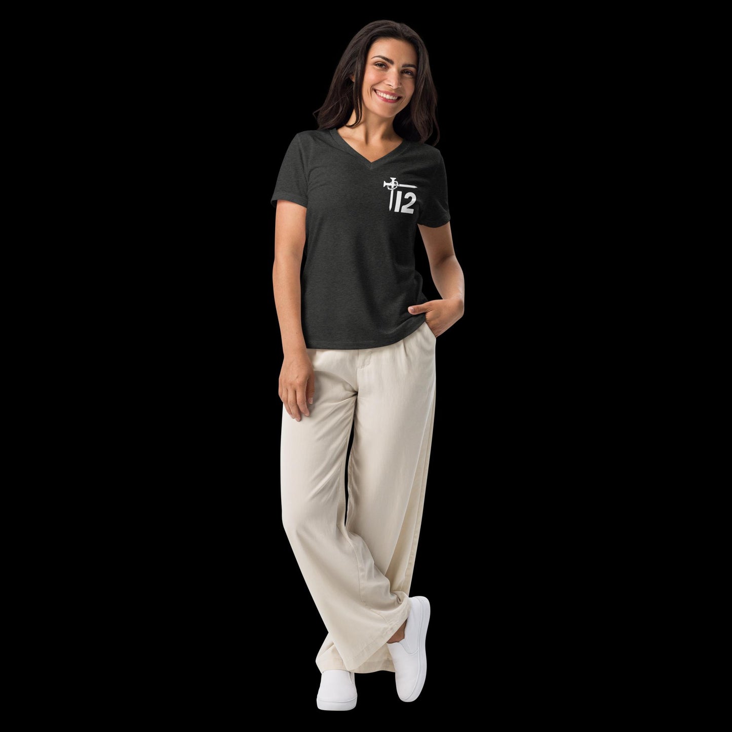 Dark Grey Christian Women’s V-Neck T-Shirt – Relaxed fit short-sleeve tee featuring white “12T” logo with cross nail and crown of thorns, modeled with cream wide-leg pants and white sneakers.