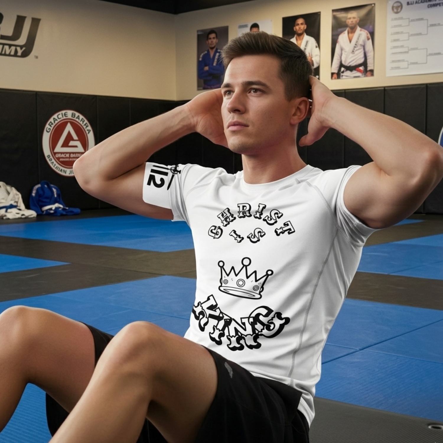 Man wearing a white “Christ Is King” Christian BJJ rash guard performing sit-ups on a Brazilian Jiu-Jitsu training mat inside a martial arts gym.