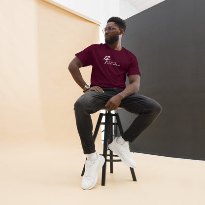 Maroon Christian Men’s T-Shirt – Classic short-sleeve tee with white “12 Twelve Testament” faith logo, modeled in a modern studio setup with dark jeans and white sneakers for a clean, casual look.